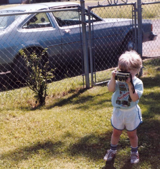 young photo of Michael Edwards with camera in hand